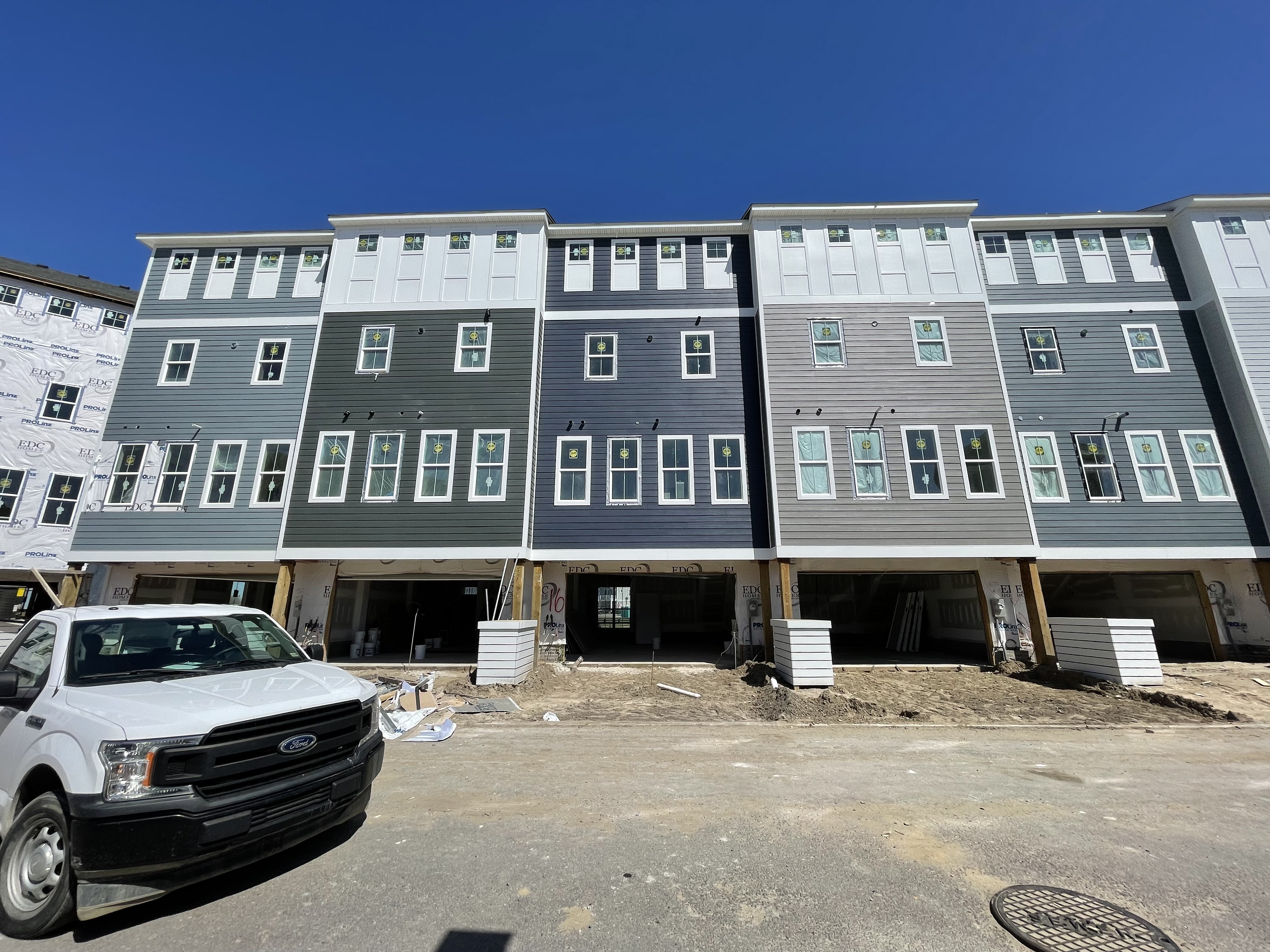 Raised coastal rowhomes with garage level